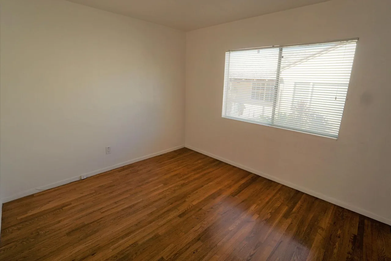Bedroom with natural light and wood floors